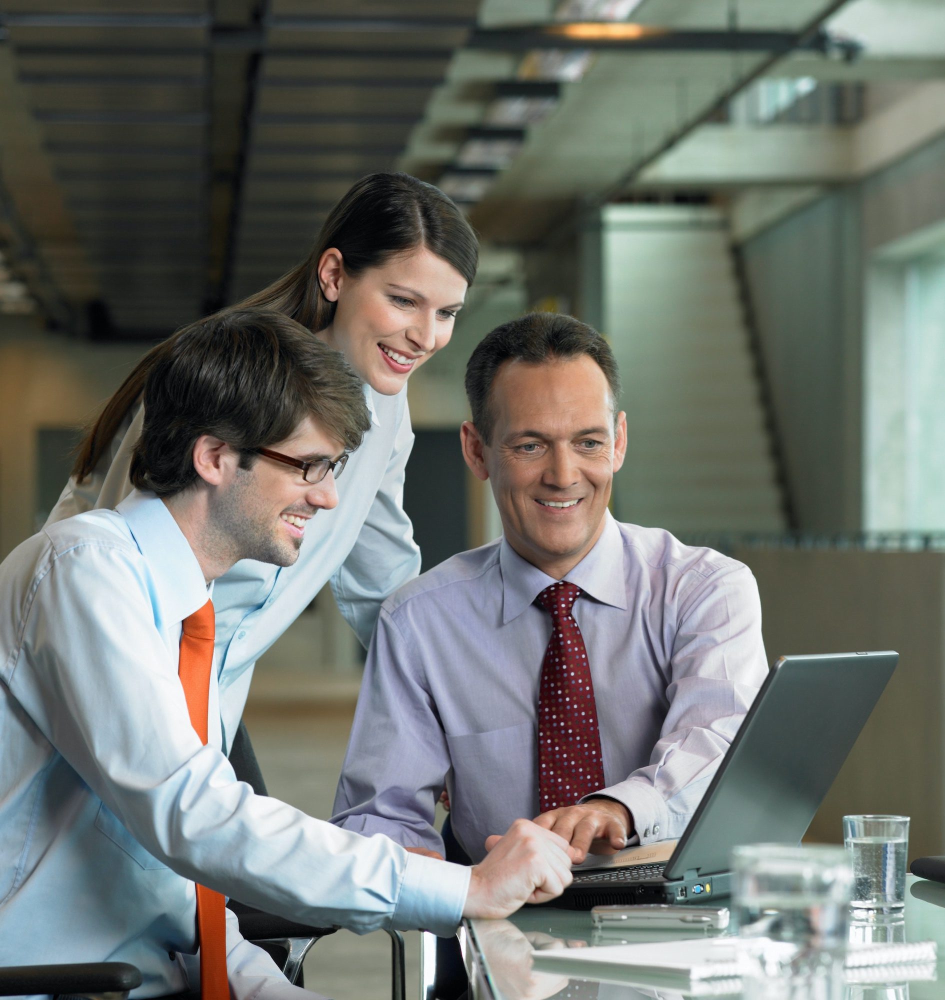 Three Businesspeople looking on laptop
